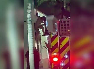 Naked, she climbs onto a roof, but misses her descent