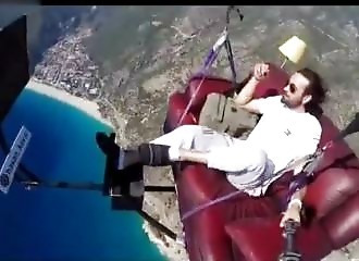 He paraglides on a couch!