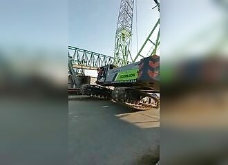 A crane collapses, sending the workers on it tumbling