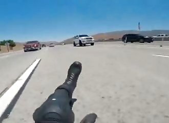 A motorcyclist crashes on a freeway and is run over by other motorists