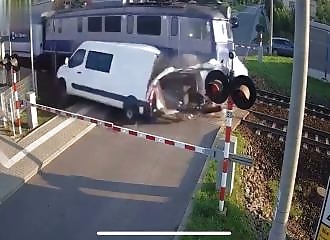 Train collides with van stuck on level crossing in Poland