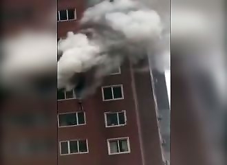 Chine : une femme accrochée à la fenêtre de son appartement en feu attend désespérément l’arrivée des pompiers