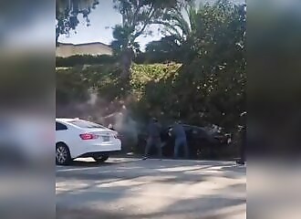 A gang rams his car, forcing him to stop and stealing everything inside