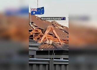 Naked, he removes all the tiles from a roof