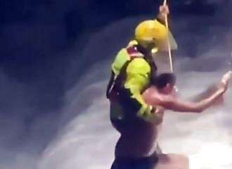 A swimmer is saved from treacherous waves that prevented him from returning to shore